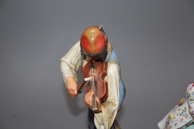 A Meissen figure of a fiddler, model R147 and another porcelain figure, tallest 24cm